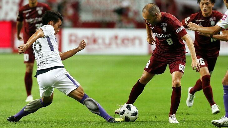 Иньеста перебрасывает мяч с ноги на ногу.