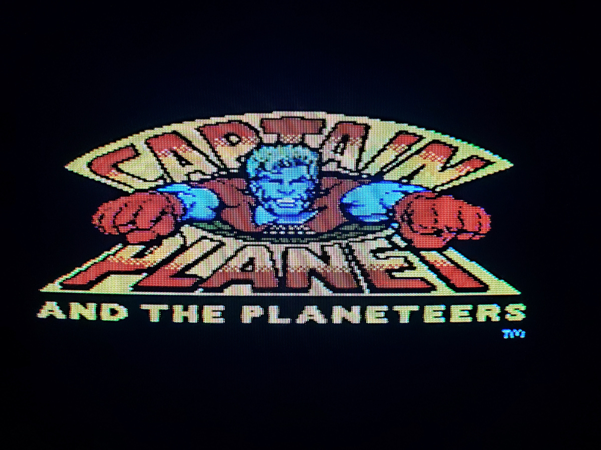 Фото сделаны мной. На фото игра Игра "Капитан Планета". Оригинал игры "Captain Planet and the Planeteers" был разработан Chris Gray Enterprises, издан Mindscape в 1992,.г. для  NES и Sega Mega Drive и других платформ. Персонажи созданы Тедом Тернером, Барбарой Пайл. Фото демонстрирует начальную заставку игры, а так же общий визуальный фон игры. Подробнее об этом рассказано в статье. Все материалы принадлежат правообладателям и размещены исключительно в информационных целях.