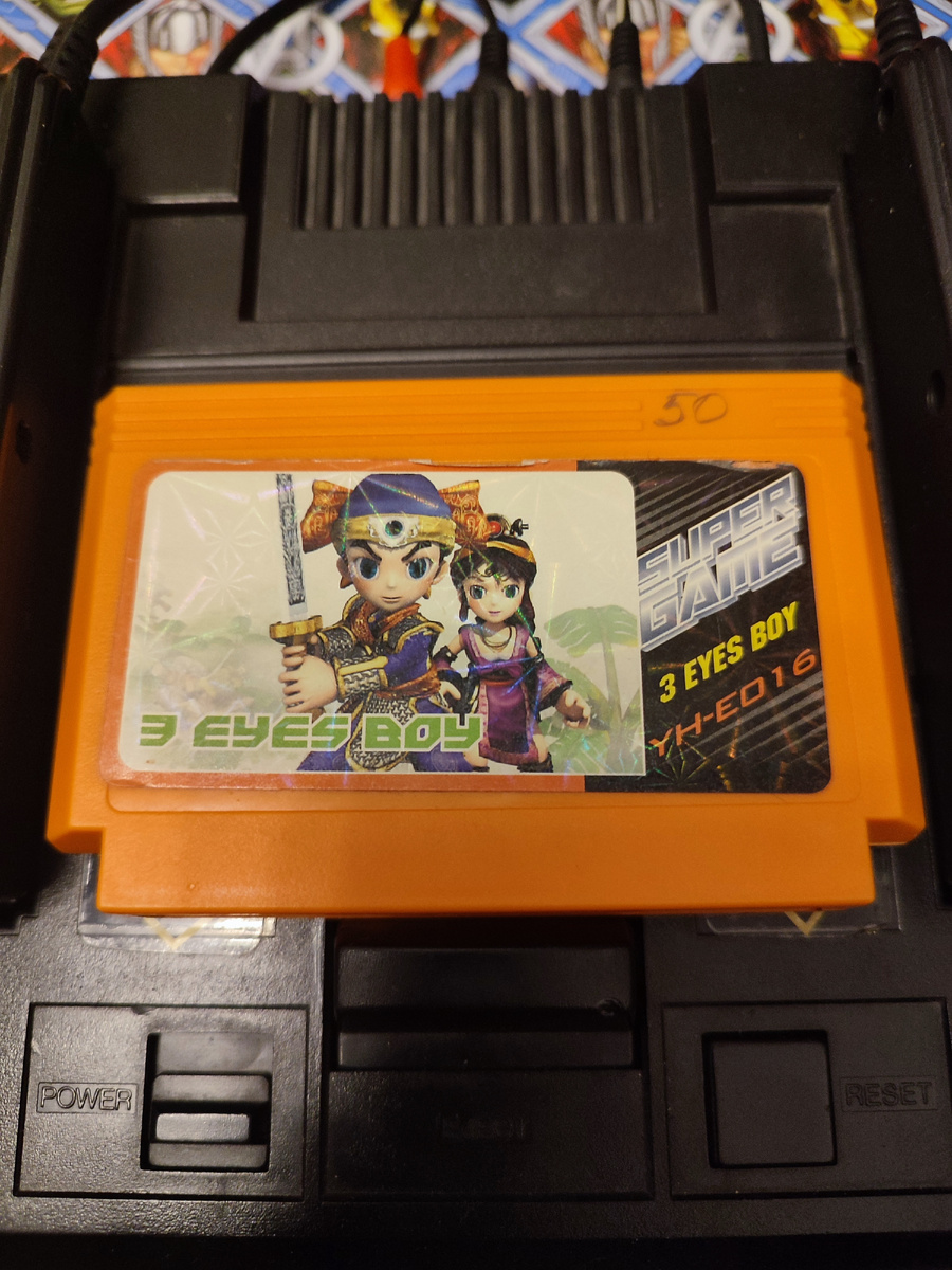 Фото сделаны мной. На фото игра "Трехглазый парень". Оригинал игры "Мицумэ га Тору" был разработан Natsume и издан Tomy в 1992,.г. для Famicom. Персонаж манги создан автором манги Осаму Тэдзука. Фото демонстрирует начальную заставку игры, а так же общий визуальный фон игры. Подробнее об этом рассказано в статье. Все материалы принадлежат правообладателям и размещены исключительно в информационных целях.