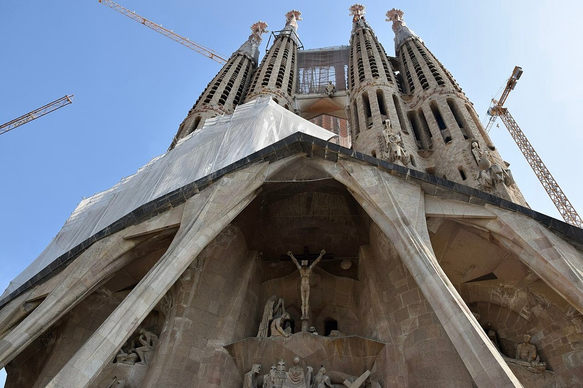 На фасаде Страстей изображены страдания и смерть Иисуса. Строгие, угловатые линии, геометрические формы и поникшие статуи резко контрастируют с фасадом Рождества. Фото: Ank Kumar / Wikimedia