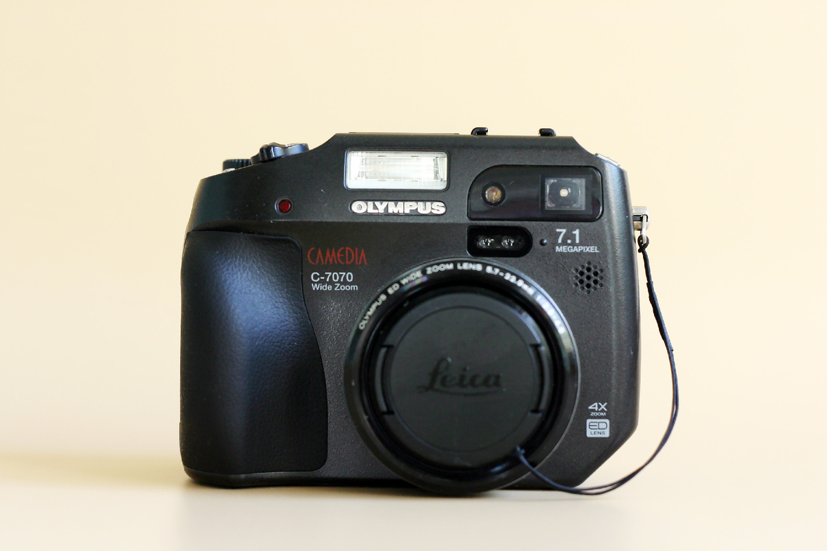 Olympus C-7070 Wide Zoom из моей коллекцией с неоригинальной крышкой объектива от фотокамеры Leica D-Lux 6