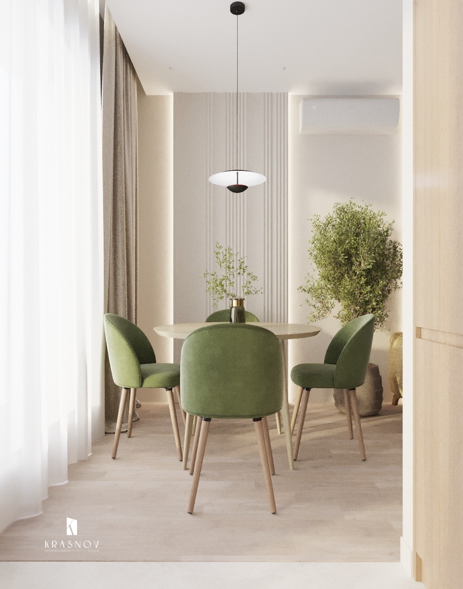 В интерьере этой кухни и столовой гармонично сочетаются натуральные материалы и мягкие оттенки, создавая атмосферу уюта и современности.

🌿 Обеденная зона оформлена изящным круглым столом и стульями с зелёной обивкой, которые придают свежесть пространству. Для акцента выбраны натуральные текстуры – дерево на полу и элементы декора. Подвесной светильник над столом добавляет интерьеру нотку минимализма и элегантности.
