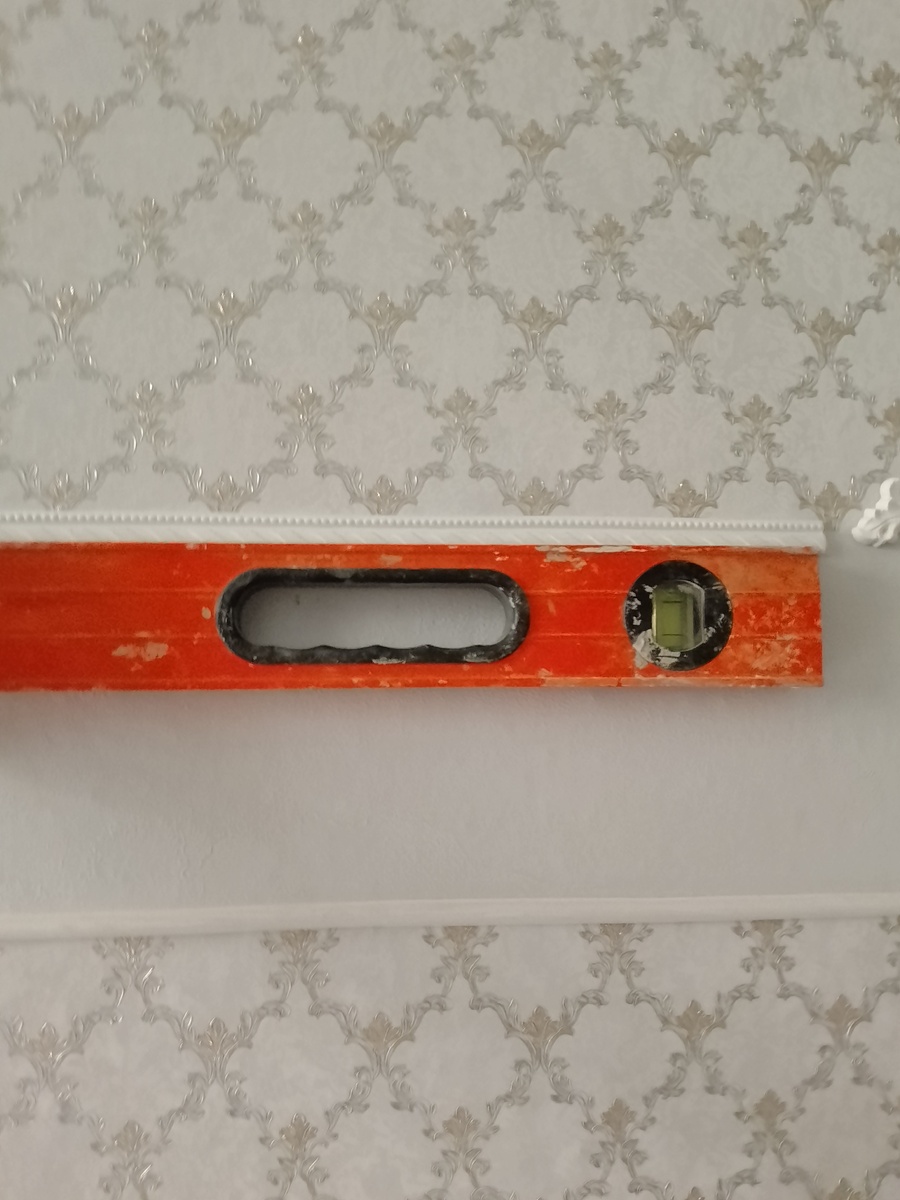 Чтобы молдинг лёг ровно используем уровень. 