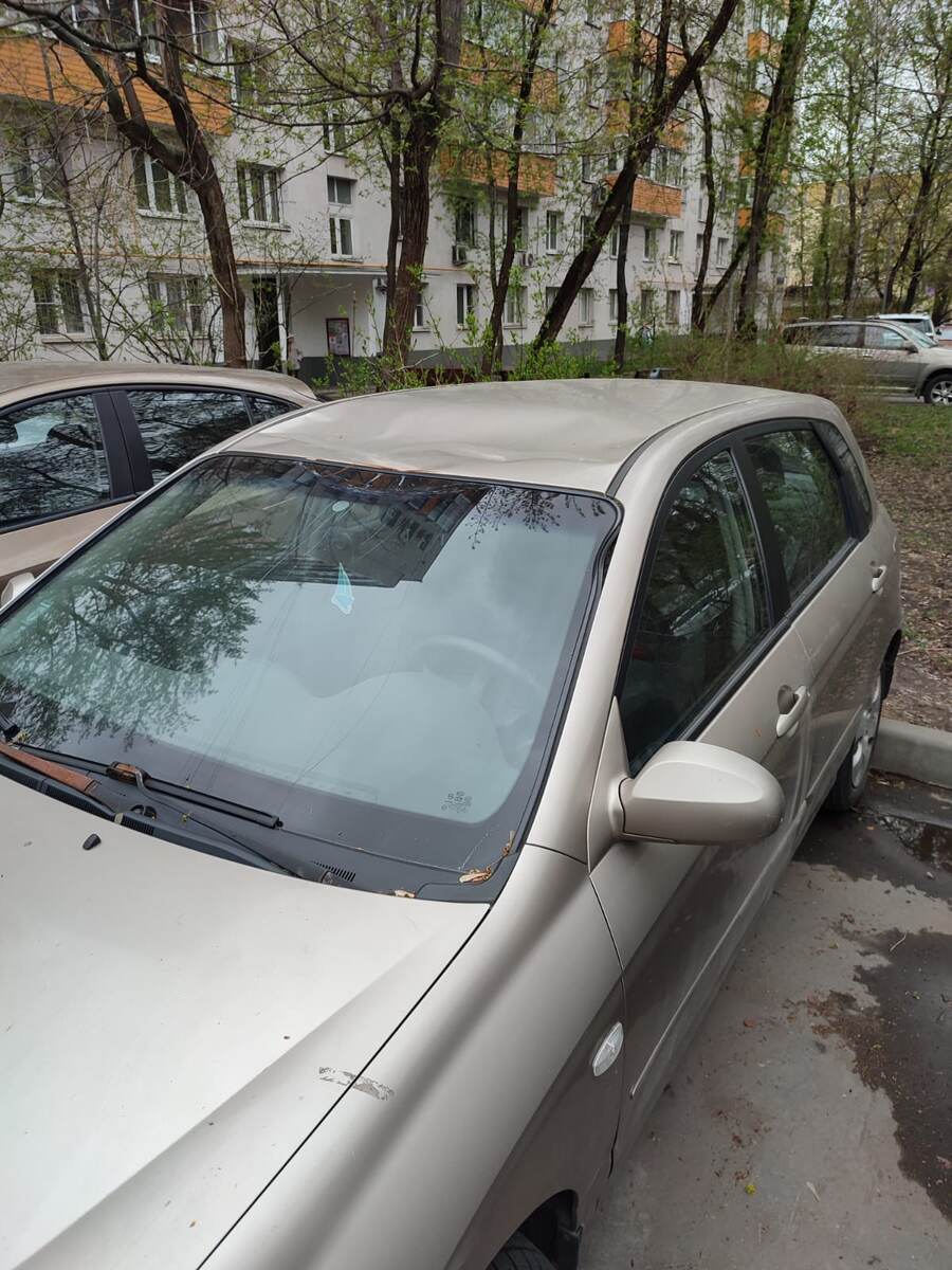 Результат падения снега на автомобиль с кровли дома при ее очистке