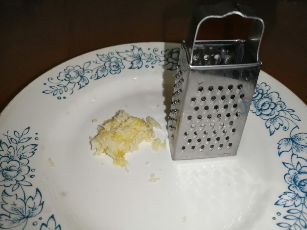 Долька чеснока пропущенная через мелкую тёрку.