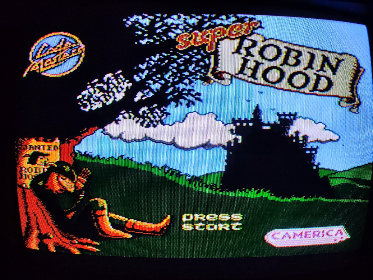 Фото сделаны мной. На фото игра "Robin Hood". Оригинал игры "Super Robin Hood" был разработан Oliver Twins (Эндрю Николас Оливер и Филип Эдвард Оливер) и издан Codemasters Software Company Limited в 1986г. для Amstrad CPC, а так же для других систем ZX Spectrum, Commodore 64, Atari ST, Amiga и NES. Игра переработана Codemasters для NES в 1993г. и выпущена под названием "Robin Hood: Legend Quest". Фото демонстрирует начальную заставку игры, а так же общий визуальный фон игры. Подробнее об этом рассказано в статье. Все материалы принадлежат правообладателям и размещены исключительно в информационных целях.