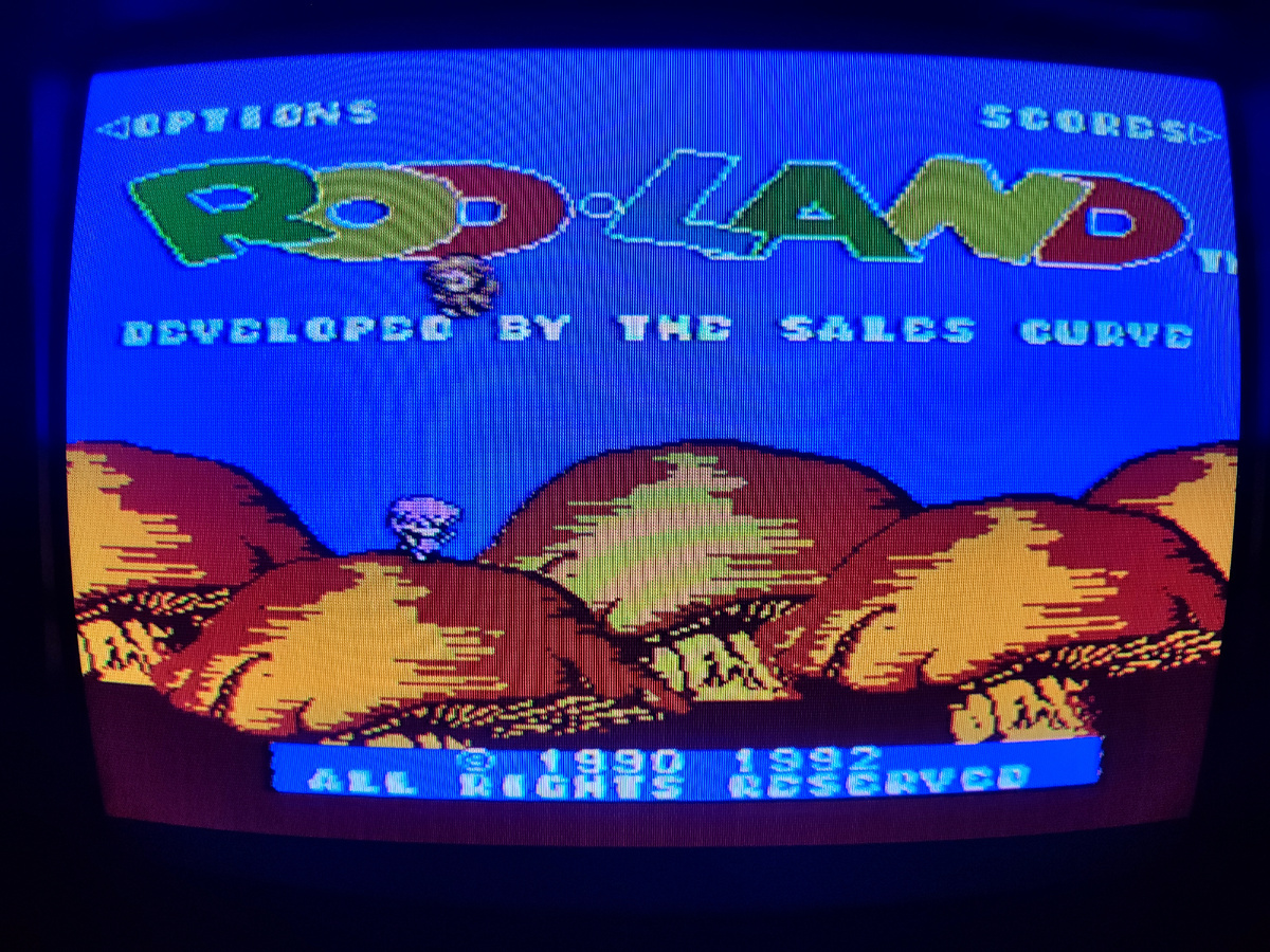 Фото сделаны мной. На фото игра . Оригинал игры "Rod Land" был разработан и издан Jaleco (для игровых автоматов) в 1990г., в создании версий участвовали The Sales Curve (для NES и др.), Eurocom (для Game Boy), Random Access (для платформы Amiga) и др. Фото демонстрирует начальную заставку игры, а так же общий визуальный фон игры. Подробнее об этом рассказано в статье. Все материалы принадлежат правообладателям и размещены исключительно в информационных целях.