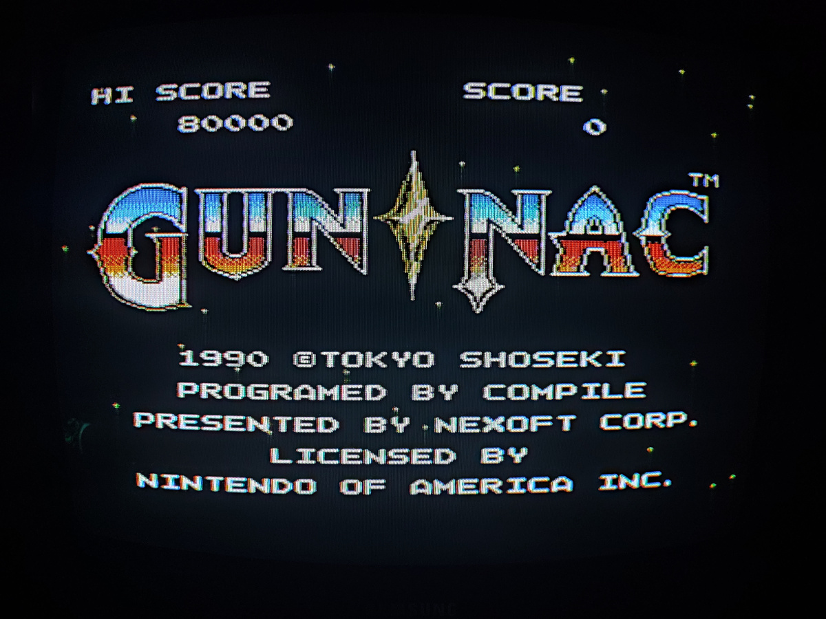 Фото сделаны мной. На фото игра "Gun-Nac". Оригинал игры "Gun-Nac" был разработан Compile и издан Tonkin House, ASCII в 1990г. для NES. Геймдизайнеры Такаюки Хироно, Коудзи Мидзута, программисты Такаюки Хироно, Кодзи Мизута. Фото демонстрирует начальную заставку игры, а так же общий визуальный фон игры. Подробнее об этом рассказано в статье. Все материалы принадлежат правообладателям и размещены исключительно в информационных целях.