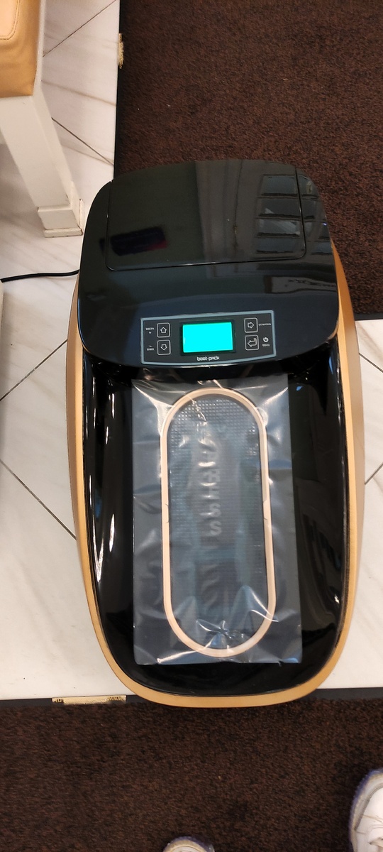 Вместо бахил - аппарат, упаковывающий подошву в плёнку. Фото автора