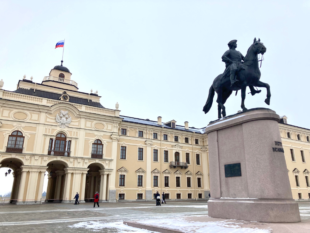 Константиновский дворец и скульптура Петру Великому. На боковых сторонах постамента прикреплены небольшие медные таблички (справа на немецком языке, слева - на русском) со словами: «Копия с памятника Петру I, исполненного в 1910 г. скульптором Густавом Шмидтом Касселем, установлена 27 мая 2003 г. в честь 300-летия основания Санкт-Петербурга». Фото автора.