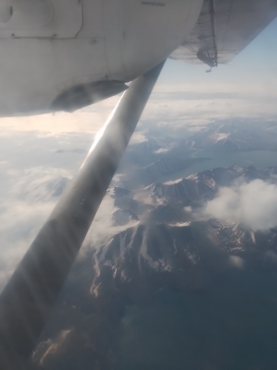 Даже в июне на сопках не тает снег. Под крылом самолёта. Фото автора.