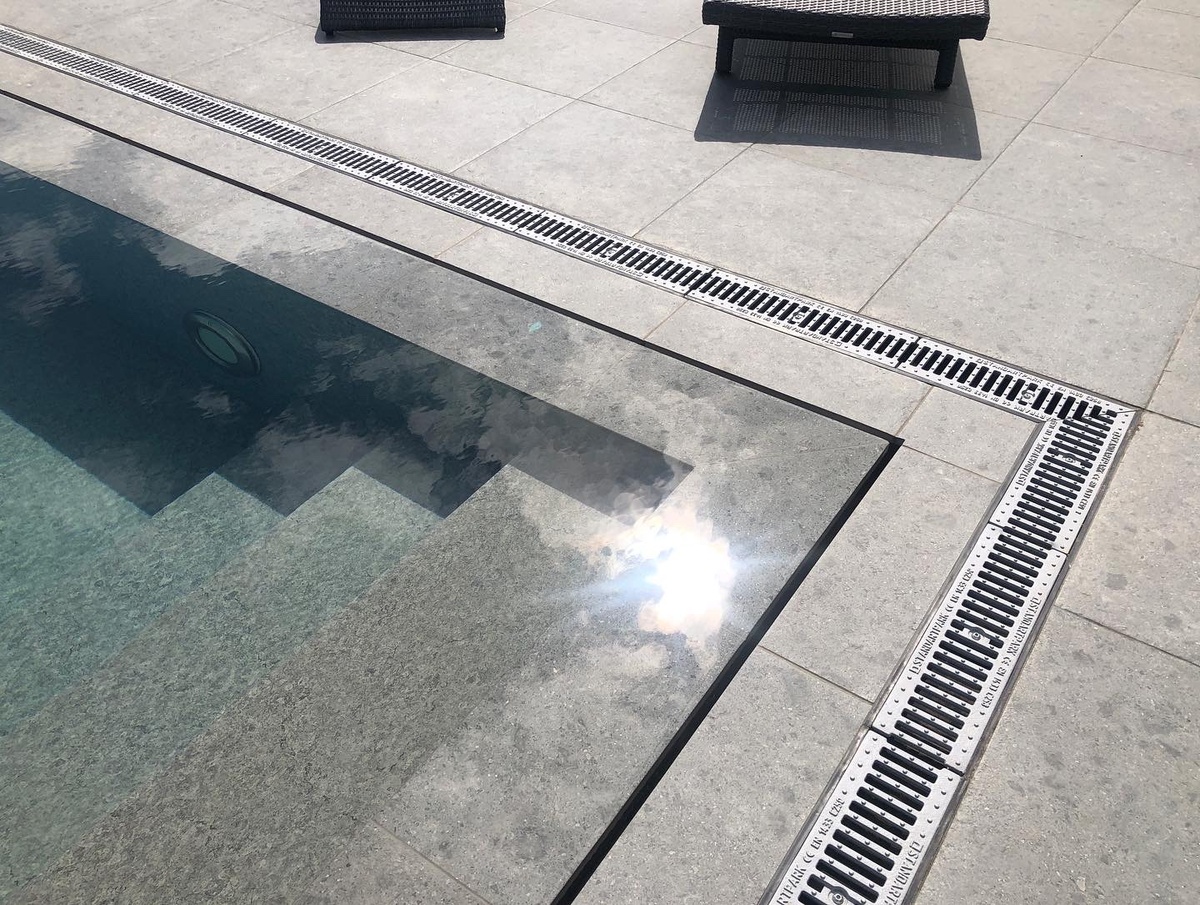 Щелевой перелив и лоток отвода поверхностной воды с прилегающей терррасы. "Аквасолар", строительство бассейнов Краснодарский край