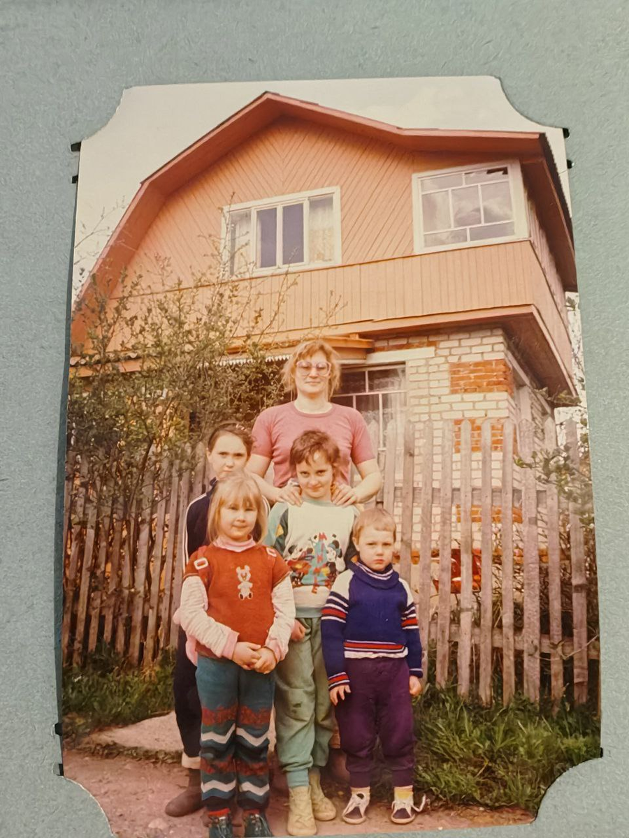 На семейно-соседском фото моя мама, я (в костюме с микки-маусом) и мой маленький недовольный брат. На заднем фоне наш дачный дом.