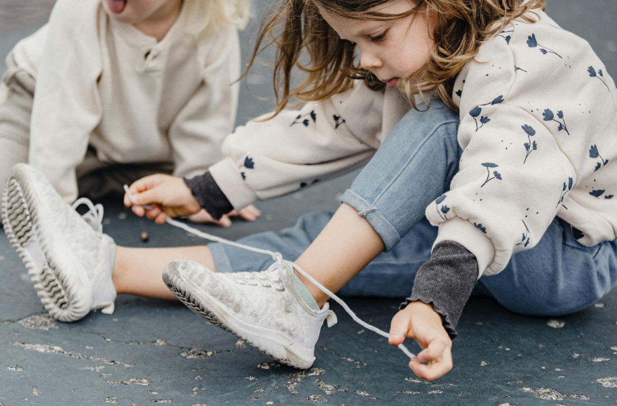 Ребенок проявляет интерес к обуви со шнурками и пытается подражать взрослым