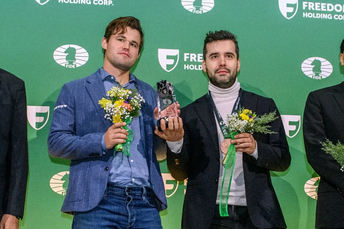 Совместное фото Магнуса Карлсена и Яна Непомнящего с чемпионским трофеем после ничьей в финале чемпионата мира по блицу 2024 года | Фото: FIDE   📷