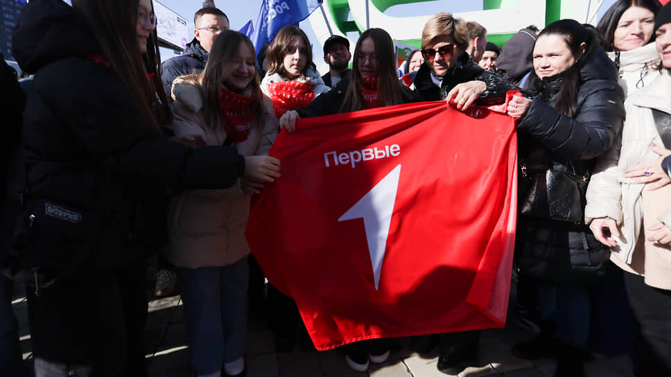 Участники митинга-концерта с флагом "Движения первых" во время мероприятия.📷Фото: Марина Молдавская / Коммерсантъ