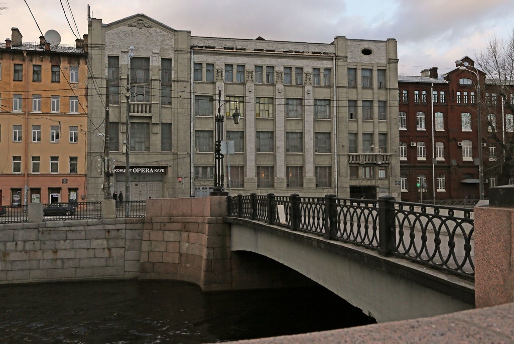 Так памятник выглядел в 2010-ых годах. Я сам видел эту надпись над входом. Я часто проходил и прохожу мимо этого задаиня до сих пор. Фигуры юноши и девуки уже давно утратили. 