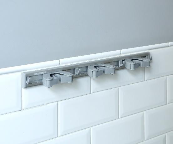 Компактный держатель с тремя гнездами, где можно хранить уборочный инвентарь в вертикальном положении