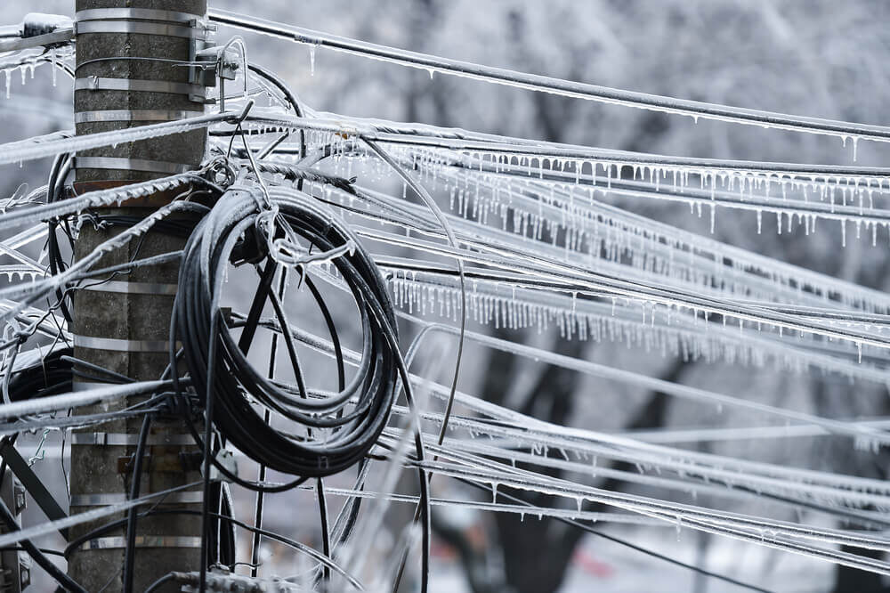    Electricity cables covered in ice after frozen rain phenomenon
