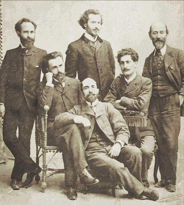 Деятели социалист-федералистской революционной партии Грузии.
В центре полулежит Георгий Деканозов (Деканозишвили). Сидят (слева направо): Арчил Джорджадзе, Михаил (Михако) Церетели. Стоят: Александр (Сандро) Габуниа, Командо Гогелиа и Варлам Черкезишвили (Черкезов). Женева. 1904