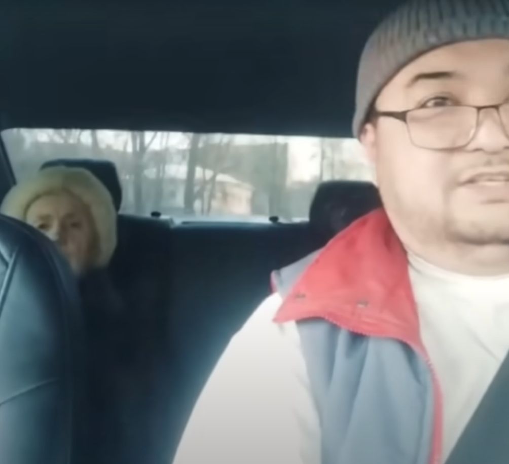 Таксист сразу же начал снимать происходящее на видео: видно, как растерянная бабушка разговаривает по телефону с мошенниками и следует их инструкциям