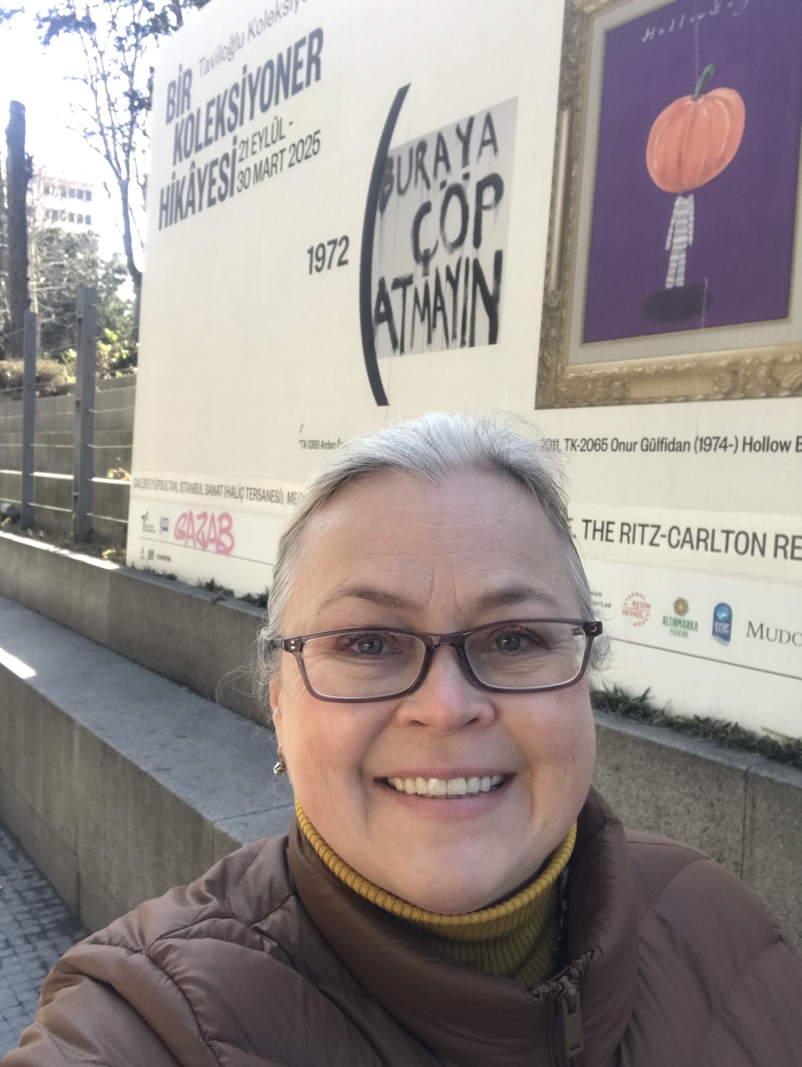 Автор статьи на фоне рекламного щита выставки