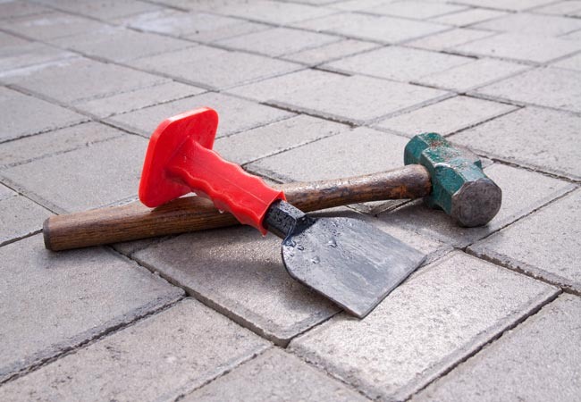 https://www.bobvila.com/wp-content/uploads/2018/04/hammer-chisel-pavers.jpg