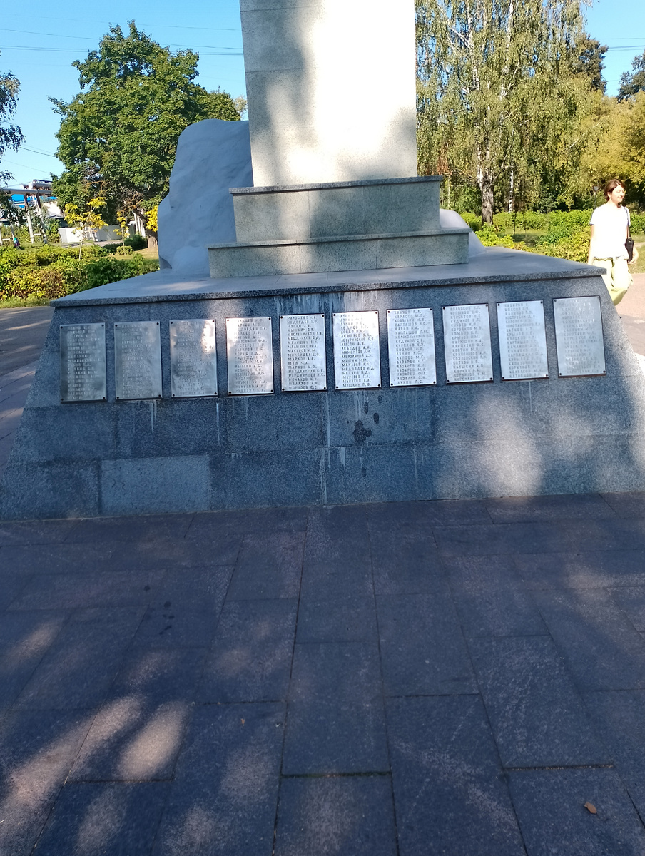 Как видите сохранилось два уступа,на которых находились мемориальные доски .Верхний ряд и украли. Искать украденные доски никто не стал. Никто не искал и подонков их укравших. В 2005 году я написал об этом памятнике  в Государственную Думу. Местная чиновничья сволочь сразу зашевелилась. Сделали вид ,что приводят в порядок территорию. То есть пришли мужики с бензопилами и подровняли кусты по мерке. Нормально подрезать кусты у нас давно не умеют, из-за чего в городе почти не осталось  декоративных кустов. А самое главное,никто не стал восстанавливать украденные доски. Я ещё раз написал  в Государственную Думу. Чиновники опять зашевелились,но от их шевеления бывает только вред. Они запросили в военкомате списки призванных с"Карболита" и погибших на войне. Но не все ,чьи имена были на памятнике работали на "Карболите" и не все Карболитовцы были призваны Орехово- Зуевским военкоматом. В ноябре 1941 года завод "Карболит"был эвакуирован в Кемерово. Кроме начальства,никто целыми семьями не эвакуировался. В одних семьях уехал муж,жена осталась,в других уехали муж и жена,остались старики и дети. Конечно всех имён не знает никто.  Поэтому на глаз определить стало ли имён меньше невозможно. Но  на памятнике было и имя моего деда-Тарасова  Сергея Ивановича.  Он как раз пошёл на войну из Кемерова. Был на "Карболите"и ещё один  Сергей Иванович Тарасов. Он не был родственником моему деду. Просто однофамилец и полный тёзка. После замены мемориальных досок остался лишь один С.И.Тарасов. Кроме того,на памятнике было имя  Героя Советского Союза Владимира Бондаренко. Он не работал на"Карболите", но его мать жила на улице Стаханова и его имя было на памятнике. А сколько ещё имён утеряно? Я ещё несколько раз писал в разные инстанции,но дело не двигается . Однажды ко мне приходили девушки из местной администрации. Они спросили:"А может будем считать ,что это ваш дед?" Когда я их спросил,а как будем считать остальных,что их вообще не было,они ничего не ответили.Была возможность восстановить