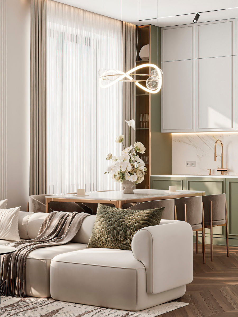 Кухня-готиная пространство, в котором соединяются функции кухни, столовой и гостиной. Светлые фасады верхних шкафов, матово-оливковые нижние и интегрированная техника — создают чистую, скандинавскую эстетику с акцентом на тепло и уют. Мягкий диван, золотистые акценты и дерево на полу добавляют уюта. Подсветка, современные светильники и продуманная эргономика — всё, чтобы с утра было приятно готовить завтрак, а вечером — устраивать домашние киносеансы.