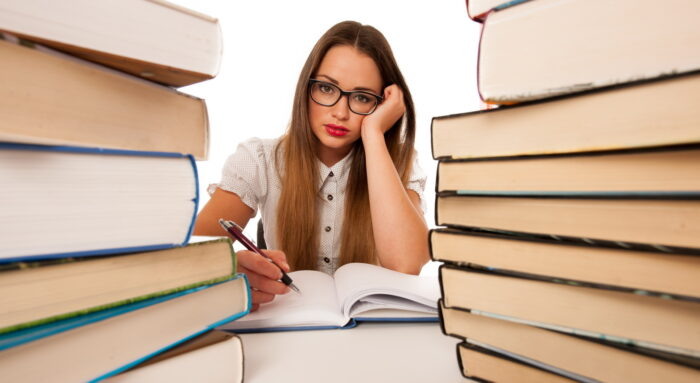    Stressed asian caucasian woman student learning in tons of books isolated Алена Васнецова