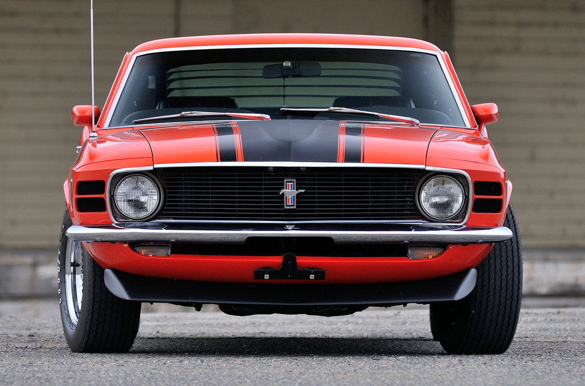    Boss 302 создан для шоссейно-кольцевых гонок SCCA Trans-Am. Предельно допустимый объем, согласно регламенту — 305,1 кубического дюйма (5 литров). Отсюда столь «скромный» мотор с заявленными 294 л.с. Разгон до 97 км/ч (60 миль/ч) примерно за 6,9 секунды вызывал усмешку у парней на «биг-блоковых» версиях, но фишка «Босса» — управляемость. Доработанная подвеска с уменьшенным клиренсом и толстыми стабилизаторами поперечной устойчивости исправно делала свое дело. Обратите внимание на аэродинамические «допы». Омологационный Mustang — один из первых серийных автомобилей с передним спойлером и одновременно антикрылом на крышке багажника. В сезоне SCCA Trans-Am 1969-го победил Chevrolet Camaro Z/28 команды легендарного Роджера «Капитана» Пенске, но на следующий год чемпионом стал Ford.   
Ford