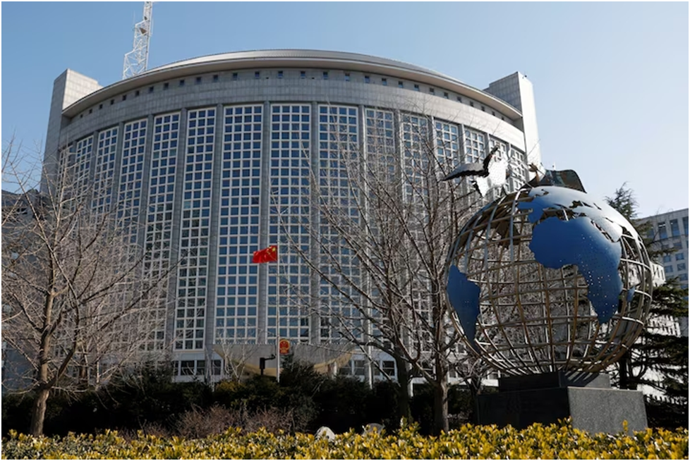 Китайский флаг развевается рядом с глобусом у здания Министерства иностранных дел Китая в Пекине, Китай, 24 февраля 2022 года. REUTERS/Карлос Гарсия Роулинс/архивное фото