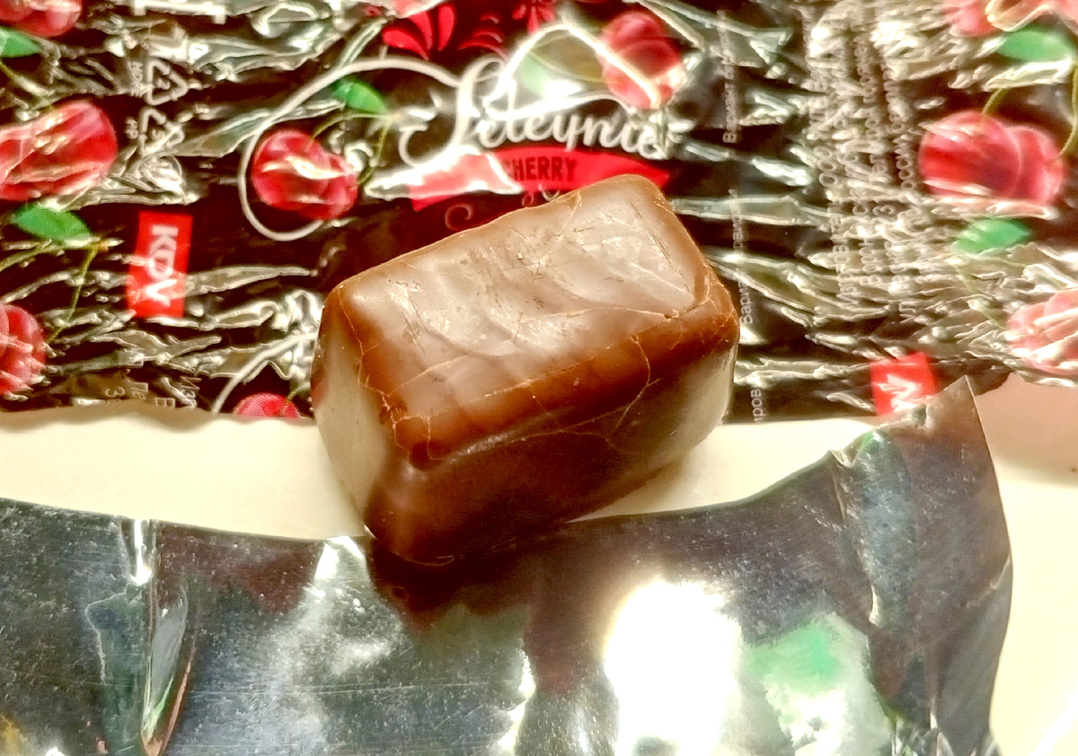 Упакована конфета в обертку с названием и адресом компании, и в фольгу.