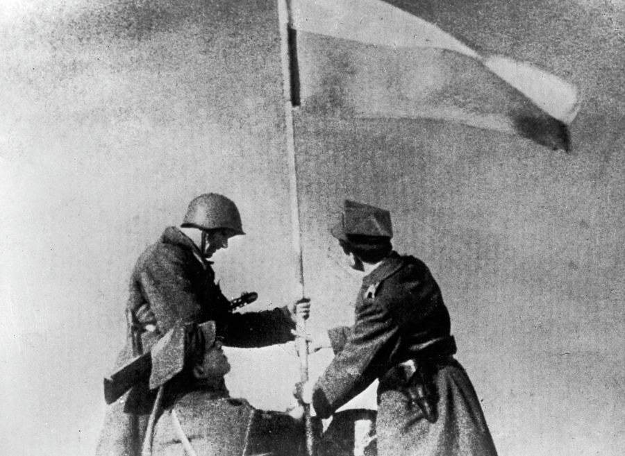    Советский солдат и боец Войска Польского водружают польский флаг над освобожденной Варшавой / Источник: © РИА Новости