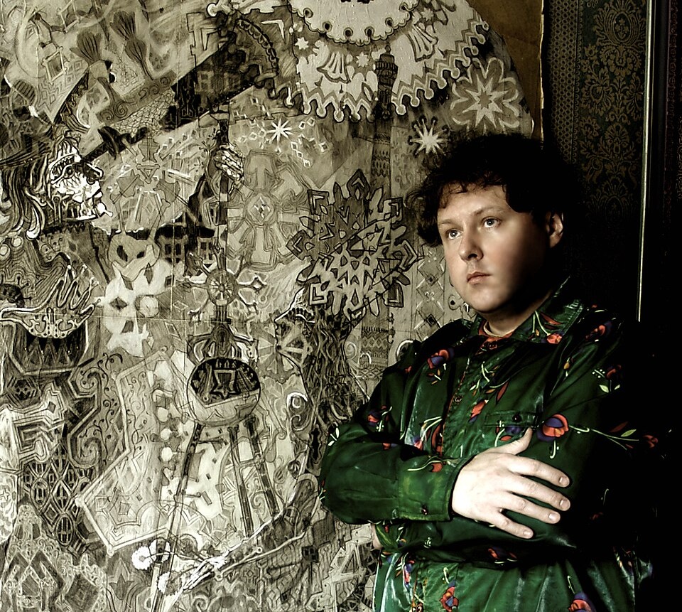 А. Акиндинов на фоне своей дипломной работы - "Звездочет". Автопортрет. Википедия