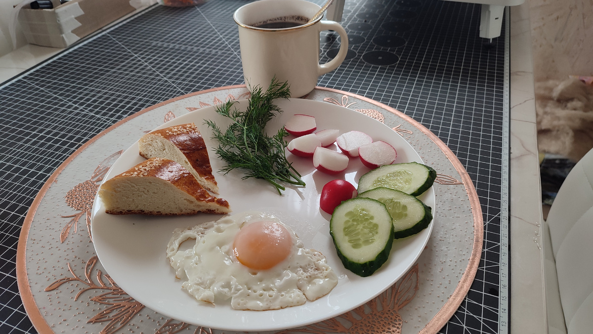 Завтрак: яйцо, лепёшка, редиска, огурцы, укроп, кофе. И ещё сливочное масло. 
