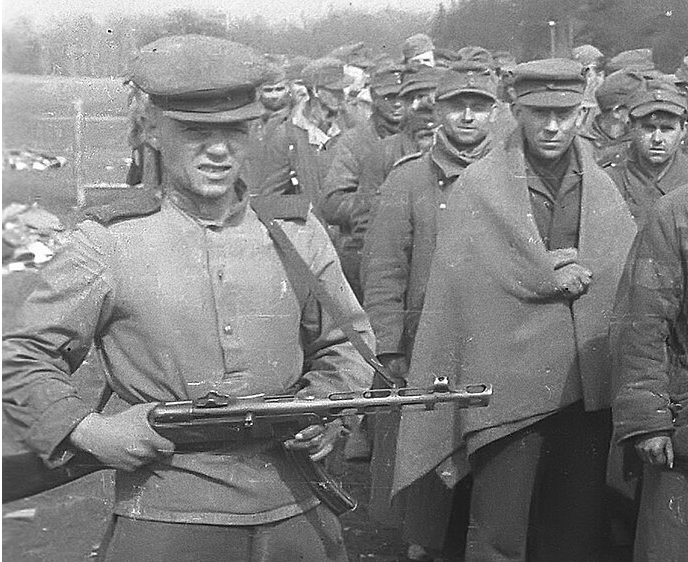 Боец с ППШ и взятые в плен немцы