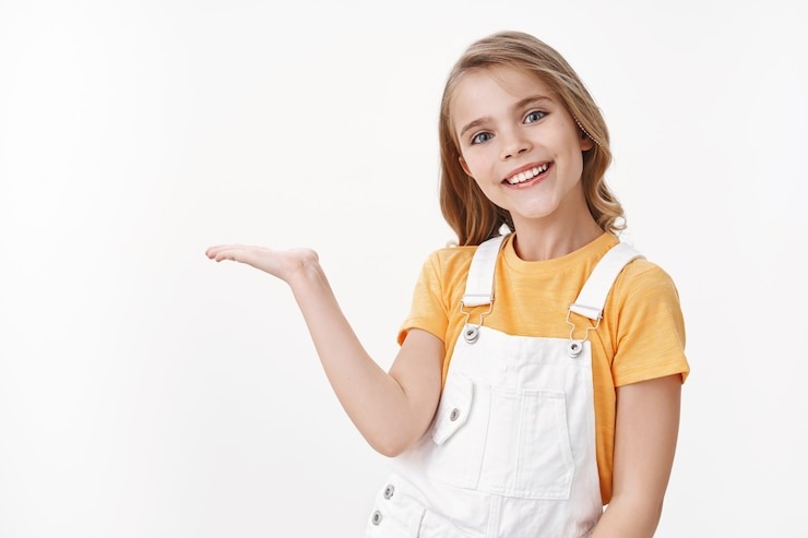 https://img.freepik.com/free-photo/pretty-clever-little-girl-child-with-blond-hairstyle-yellow-t-shirt-overalls-hold-something-palm-introduce-product-blank-white-copy-space-smiling-joyful-brag-what-she-got-b-day-present_176420-36184.jpg?ga=GA1.1.1823312839.1738931887&semt=ais_hybrid&w=740