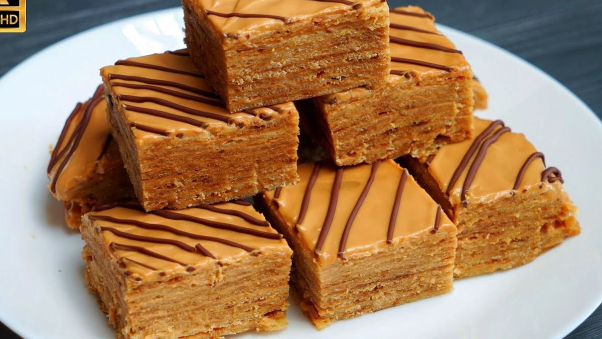 Торт на сковороде

Мука – 220 гр.
Яйцо – 2 шт.
Соль – 0,5 ч.л.
Масло сливочное – 130 гр.
Мед – 100 гр.
Сода – 1 ч.л.
Вареная сгущенка – 150 гр.
Сметана 20% - 200 гр.

В небольшую кастрюлю кладите 130 гр. сливочного масла, 2 яйца, 100 гр меда, щепотку соли. Поставьте на водяную баню. Перемешайте. Когда масса полностью соединиться и растает, добавьте 1 ч.л. соды. Снова перемешайте. Масса начнет пениться. Теперь добавьте немного муки от общего количества, перемешайте. Можно снять с огня и немного остудить. Добавьте оставшуюся муку и замесите тесто. 
Переложите его на доску. Разделите на 8 частей. Каждую раскатайте в тонкий круг. Выложите на сухую сковороду и выпекайте с двух сторон по одной-две минуте. Лучше всего это делать на среднем огне, чтобы коржи не пригорели. Испеките все коржи и приготовьте по быстренькому крем.  Просто возьмите 150 гр. вареной сгущенки. Добавьте 200 гр. 20% сметаны. Перемешайте хорошенько и крем готов. 
Теперь обильно смажьте кремом все коржи. Уберите на пропитку в холодильник на пару часов. Можете украсить тортик по своему желанию. Я просто растопила шоколад и сделала полосы. Нарезайте на удобные порции и подавайте к чаю. Очень вкусный, мягкий, ароматный. 
 Приятного чаепития!