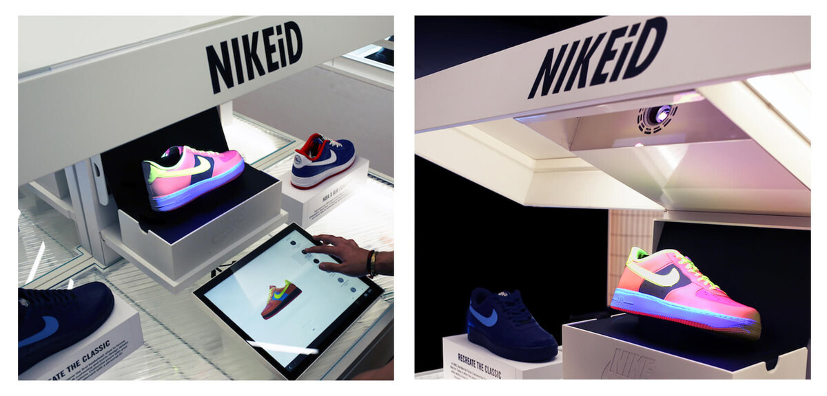 Стенд NIKEiD проецирует цветное изображение на модель кроссовок белого цвета.