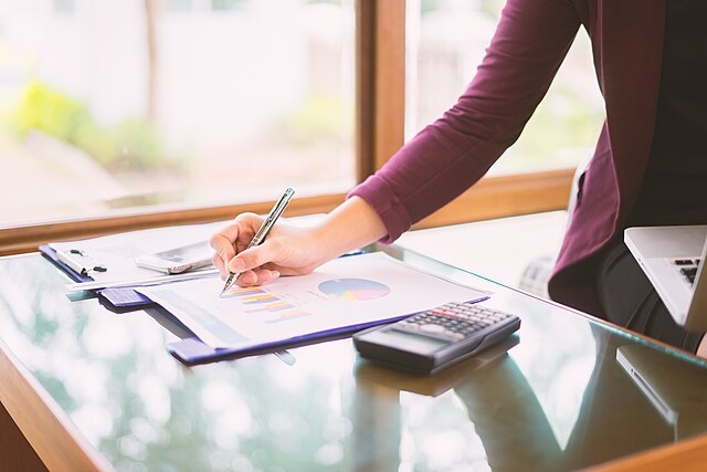    Hand business woman pointing paper data analyze chart on desk at office room.young girl writing into her diary about recipient address on mailing envelope,female hands sending letter,business concept Василий Соколов