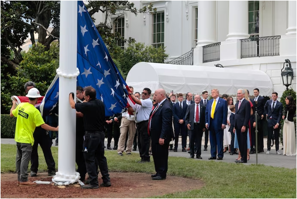 Президент Дональд Трамп наблюдает за тем, как в среду поднимают американский флаг на недавно установленном флагштоке в Белом доме. (Чип Сомодевилла/Getty Images)