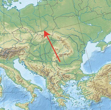 Та же стрелка, но теперь она красная. а не зеленая. На фоне Карпатских Гор и Вислы