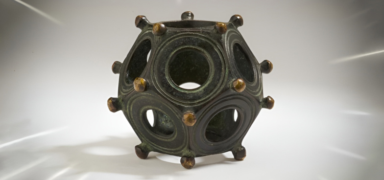 Римские додекаэдры — загадочные бронзовые артефакты времён Римской империи, датируемые II–III веками нашей эры. Они представляют собой полые двенадцатигранники диаметром от 4 до 11 см с отверстиями на каждой грани — причём все разного размера. Известно около 130 таких объектов, найденных на территории современной Франции, Германии, Швейцарии, Бельгии, Нидерландов, Австрии и Великобритании. Для чего они служили — до сих пор загадка.