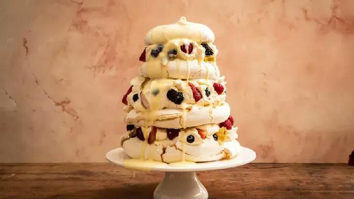 Mixed berry pavlova with poached rhubarb and orange-ginger curd