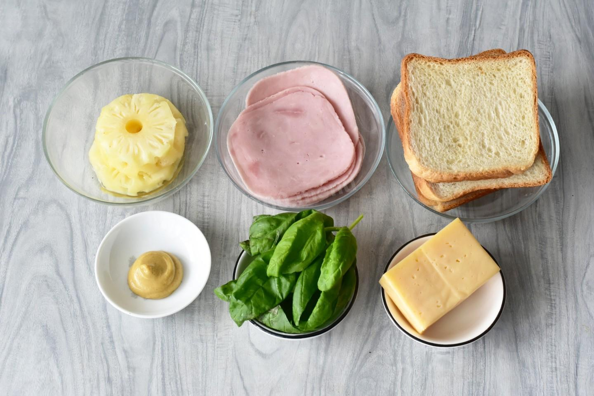 Как сделать бутерброды с ананасом и сыром в духовке? Для начала подготовьте все необходимые ингредиенты по списку. Вместо тостового хлеба можете использовать батон. Хлеб лучше покупать в нарезке. Так вы сэкономите себе время. К тому же одинаково нарезанные ровные ломтики красивей смотрятся на столе.