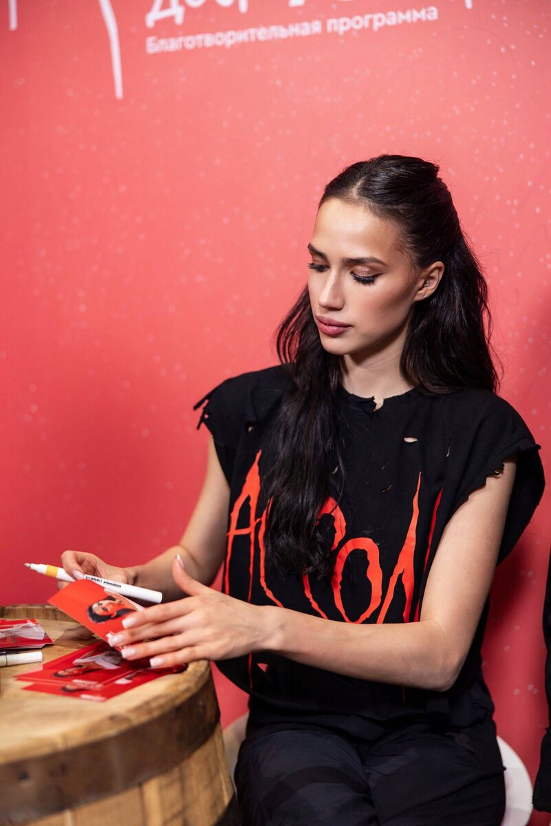 Алина Загитова подписывает буклеты