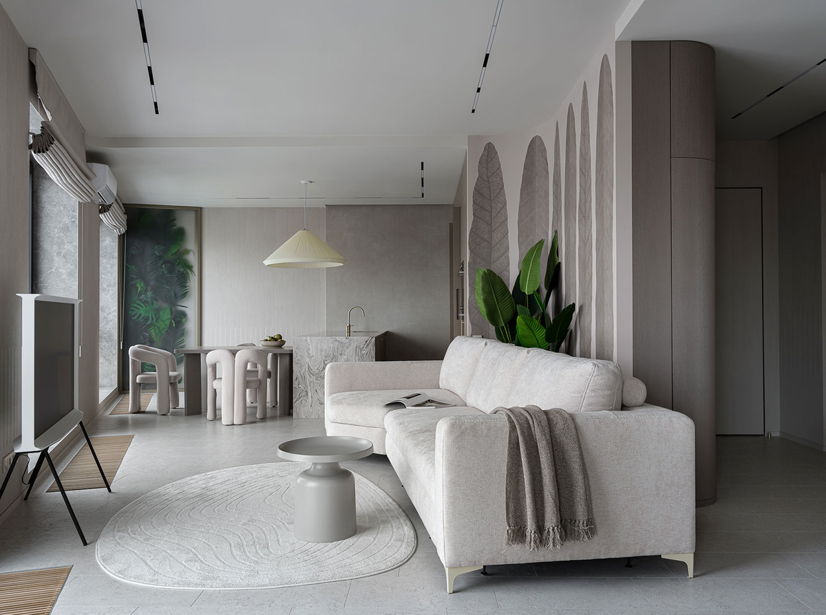 В столовой квартиры в ЖК Wellton Towers мы сделали панель с матовым стеклом, за которым расположили искусственные растения с красивыми силуэтами.