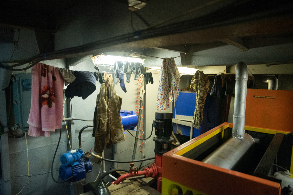 Быт внутри плашкоута. Вещи сушатся в генераторной. Автор фото Нина Штромберг