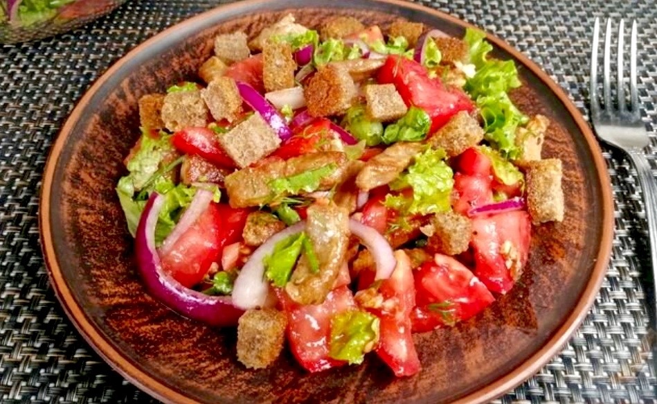 Салат с говядиной, помидорами и ржаными чесночными сухариками.